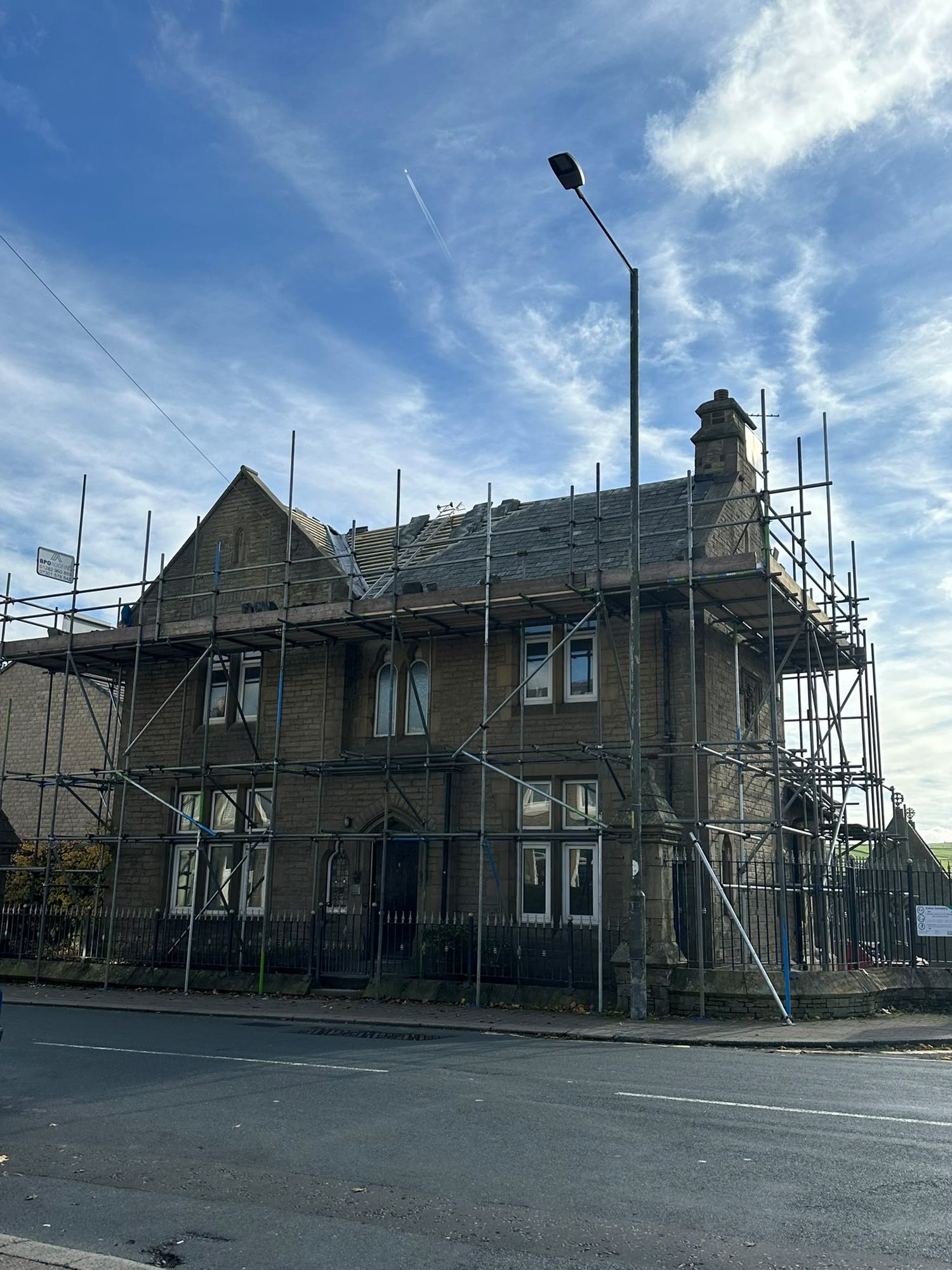 Large stone property fully scaffolded for roofing works in East Lancashire